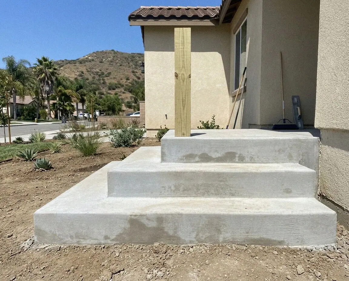 A rebuilt concrete stair and handrail at a Riverside, CA porch